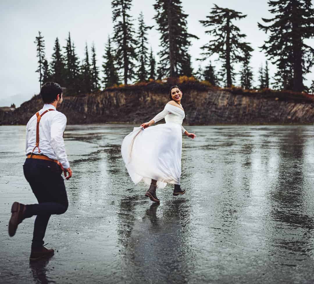 artist point elopement, couple running together after saying their vows