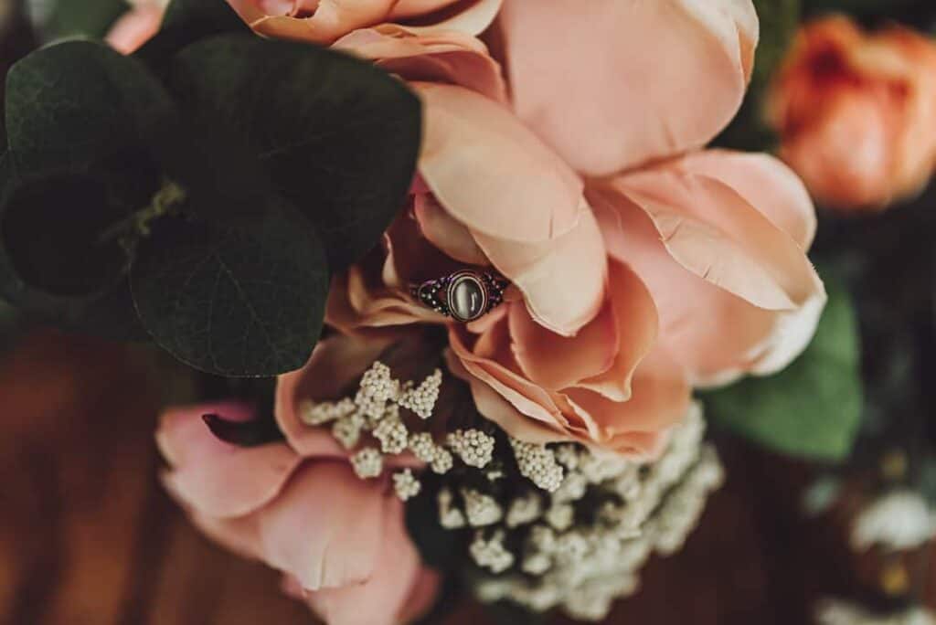 artist point elopement guide wedding ring hidden in florals